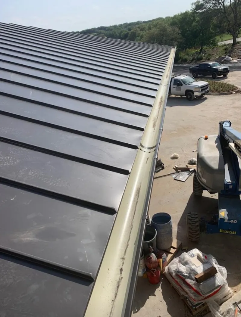 Standing seam panel and gutter detail on a metal roofing jobsite in North Branch
